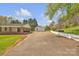 Wide shot of property featuring the house, garage, carport and long driveway at 1975 Old Wilkesboro Rd, Taylorsville, NC 28681