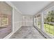 Cozy sunroom with tile floor, wainscotting and large windows showcasing backyard views at 1975 Old Wilkesboro Rd, Taylorsville, NC 28681