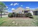 This home features a well-maintained backyard with a brick wall, green lawn, and access to a screened porch at 20202 Dovekie Ln, Indian Land, SC 29707
