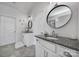 Dual vanities with granite countertops and white cabinets in a well-lit bathroom at 20202 Dovekie Ln, Indian Land, SC 29707