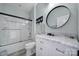Clean, bright bathroom features marble countertops, modern vanity, and glass enclosed tub and shower at 20202 Dovekie Ln, Indian Land, SC 29707