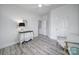 Serene bedroom with soft lighting, wood flooring, and a chest of drawers with adjacent chair at 20202 Dovekie Ln, Indian Land, SC 29707