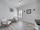 Inviting bedroom with natural light, wood flooring, and matching chairs and artwork at 20202 Dovekie Ln, Indian Land, SC 29707