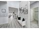 Bright hallway with hardwood flooring, modern decor, and views into the living room at 20202 Dovekie Ln, Indian Land, SC 29707