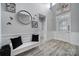 Light and airy hallway with a decorative mirror, bench, and high ceilings at 20202 Dovekie Ln, Indian Land, SC 29707