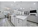 Gorgeous kitchen island featuring sink and dishwasher has an open view of living room and dining area at 20202 Dovekie Ln, Indian Land, SC 29707