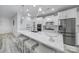 Stunning white kitchen featuring island seating, stainless steel appliances, and pendant lighting at 20202 Dovekie Ln, Indian Land, SC 29707
