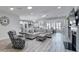 Spacious living room boasts wood flooring, a fireplace, and an open layout to kitchen and dining areas at 20202 Dovekie Ln, Indian Land, SC 29707