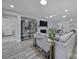 Inviting living area features modern decor, wood floors, fireplace, and seamless flow into adjacent spaces at 20202 Dovekie Ln, Indian Land, SC 29707