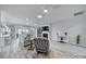 Bright, open-concept living room features wood floors, modern lighting, and a decorative fireplace at 20202 Dovekie Ln, Indian Land, SC 29707