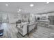 Open-concept living space with wood flooring, stylish furnishings, and easy access to the kitchen at 20202 Dovekie Ln, Indian Land, SC 29707