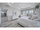 Bright main bedroom showcasing tray ceiling, large windows, and a dresser at 20202 Dovekie Ln, Indian Land, SC 29707