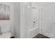 Bathroom features a tub and shower combo with a white shower curtain and a toilet at 212 S Columbia St, Gastonia, NC 28054