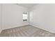 Neutral bedroom offers neutral carpet, one window, and ample closet space at 212 S Columbia St, Gastonia, NC 28054