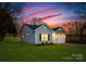 Charming single-story home with gray siding, black shutters and beautiful landscaping at 212 S Columbia St, Gastonia, NC 28054