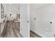 Hallway leading into the living area, including a laundry room and modern flooring at 212 S Columbia St, Gastonia, NC 28054