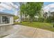 Spacious backyard with mature trees and a concrete patio, perfect for outdoor entertaining at 2138 Syracuse Dr, Charlotte, NC 28216