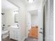 Bathroom with white fixtures, a shower-tub combo, and an open doorway to another room at 2138 Syracuse Dr, Charlotte, NC 28216