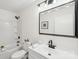 Well-lit bathroom featuring a modern vanity, toilet, shower, tub, and classic tile at 2138 Syracuse Dr, Charlotte, NC 28216
