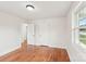 Empty bedroom with hardwood floors, white walls, and window with natural light at 2138 Syracuse Dr, Charlotte, NC 28216
