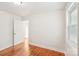 Bright bedroom with hardwood floors, white walls, and natural light at 2138 Syracuse Dr, Charlotte, NC 28216