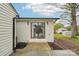 Charming exterior with white painted brick, black trim, and a sliding glass door at 2138 Syracuse Dr, Charlotte, NC 28216