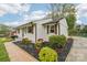 Charming, renovated single-story home with beautifully manicured flower beds and a paved sidewalk at 2138 Syracuse Dr, Charlotte, NC 28216