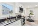 Bright kitchen with stainless steel appliances and adjacent breakfast nook with natural light at 2138 Syracuse Dr, Charlotte, NC 28216