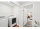Well-lit laundry room with modern washer and dryer units and an open doorway to the bedroom at 2138 Syracuse Dr, Charlotte, NC 28216