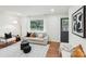 Bright living room with hardwood floors and modern neutral-toned furnishings at 2138 Syracuse Dr, Charlotte, NC 28216
