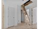 Attic access with a wooden ladder, white walls, and visible framing, showcasing the home's structure at 2628 S Main St, Kannapolis, NC 28027