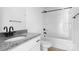 Well-lit bathroom featuring granite countertops, a white toilet, and a shower tub at 2628 S Main St, Kannapolis, NC 28027
