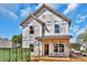 Exterior view of a two-story home under construction, featuring a covered porch, house wrap, and visible framing details at 2628 S Main St, Kannapolis, NC 28027