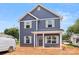 Two-story home featuring a blue exterior, gray shutters, and a welcoming front porch at 2628 S Main St, Kannapolis, NC 28027