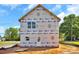 A two-story home exterior with protective wrap; waiting for its final finishing and appealing landscaping at 2628 S Main St, Kannapolis, NC 28027