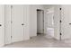 Hallway area featuring neutral carpeting, white walls and trim, and open doorways into adjoining rooms at 2628 S Main St, Kannapolis, NC 28027