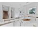Spacious kitchen with white cabinets, black handles, and natural light streaming through the windows at 2628 S Main St, Kannapolis, NC 28027