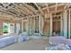 Unfinished living room with exposed framing and staircase, prior to insulation at 2628 S Main St, Kannapolis, NC 28027