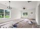 Bright living room with large windows, ceiling fan, and doorway at 2628 S Main St, Kannapolis, NC 28027