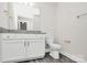 Bathroom features a granite countertop, a toilet and a large mirror above the counter at 2628 S Main St, Kannapolis, NC 28027