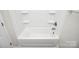 A clean bathtub is surrounded by shelves and a white shower enclosure at 2628 S Main St, Kannapolis, NC 28027