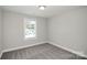 Neutral colored bedroom with carpet, a window, and white trim at 2628 S Main St, Kannapolis, NC 28027