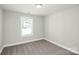 This bedroom is a cozy space featuring soft carpeting, a window and neutral wall color at 2628 S Main St, Kannapolis, NC 28027