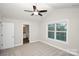 Bedroom with a view of the bathroom, carpeted floor and a window allowing natural light at 2628 S Main St, Kannapolis, NC 28027