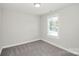 Neutral colored bedroom with carpet, a window, and white trim at 2628 S Main St, Kannapolis, NC 28027