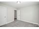 Neutral colored bedroom with carpet and two white doors at 2628 S Main St, Kannapolis, NC 28027