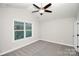 Spacious bedroom with a ceiling fan and a large window offering scenic views at 2628 S Main St, Kannapolis, NC 28027