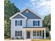 Charming two-story home featuring a covered front porch and a well-maintained lawn at 2628 S Main St, Kannapolis, NC 28027