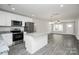 Bright kitchen features stainless appliances, granite countertops, and a center island for ample workspace at 2628 S Main St, Kannapolis, NC 28027