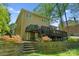 A sprawling backyard features a multi-tiered deck, stone retaining wall, lush lawn, and garden at 273 S Downs Way, Fort Mill, SC 29708